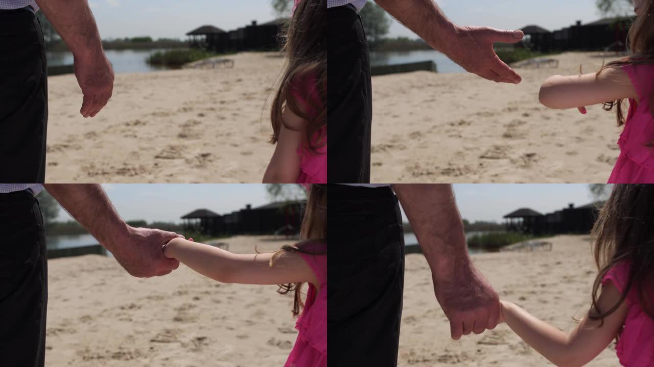 祖父牵着孙女的手。他们正在海滩上散步。4k慢速移动