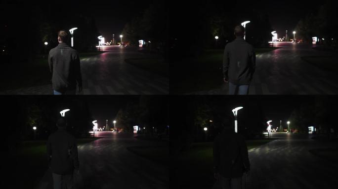 一个年轻人在傍晚沿着林荫大道行走。