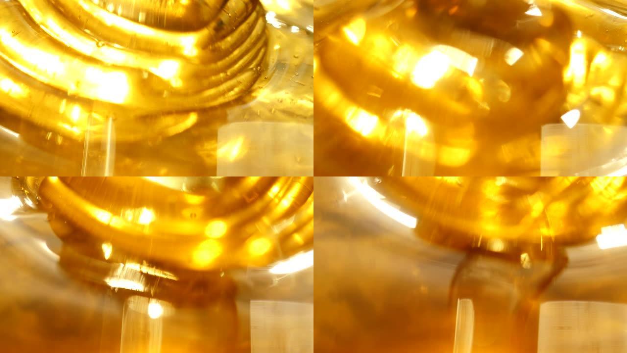 新鲜的金色蜂蜜倒入微距镜头