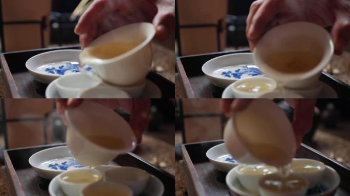 茶师将绿茶倒入茶杯中，以供盖碗或钟。中国传统功夫或功夫茶道。中国传统文化的元素。特写。4k