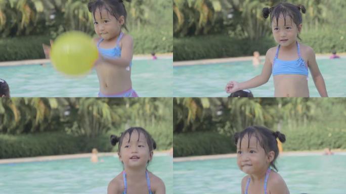 亚洲小男孩和女孩雷莱克斯喜欢在游泳池里打球