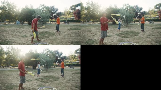 三个年轻的成年杂耍演员在公园一起训练