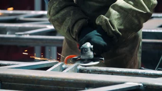 工厂用角磨机抛光焊缝。使用工业仪器