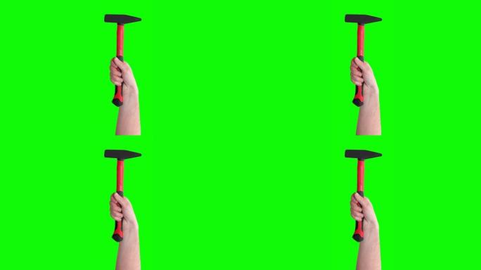 手举红色锤子，工具隔离在绿色屏幕上。机械工具概念