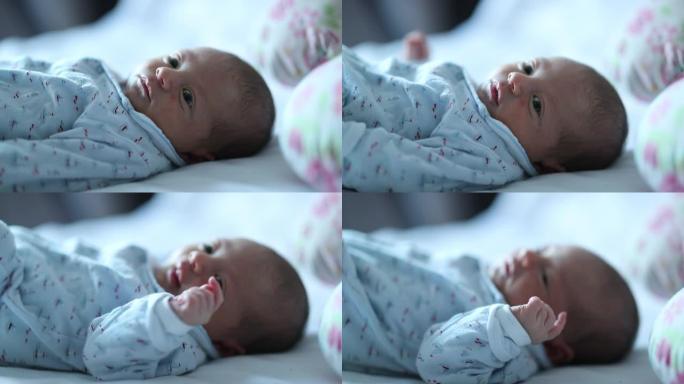 微小的新生婴儿好奇地观察世界婴儿在生命的第一周寻找相机