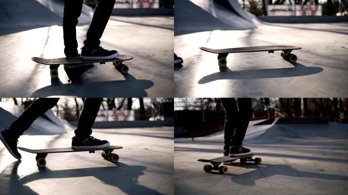 带着滑板的男孩正要开始他的旅程。滑板城市公园里的少年溜冰者。滑板上的脚的近距离开始一个骑行。镜头耀斑