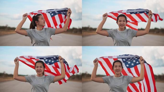 快乐的亚洲妇女与美国国旗美国庆祝7月4日