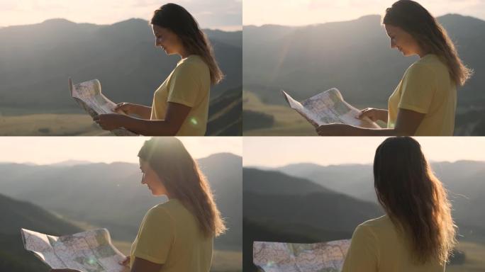 肖像。一位长发女游客站在悬崖边上，手里拿着地图，正在寻找旅行路线。