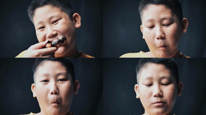 大身材的亚洲青春期男孩边摸肚子边吃甜甜圈，在弱光下慢动作。
