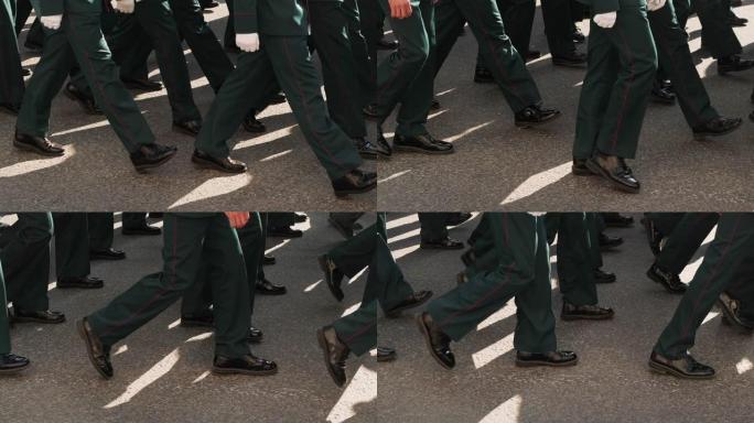 近距离拍摄在城市广场游行队伍中穿着靴子的军人。
