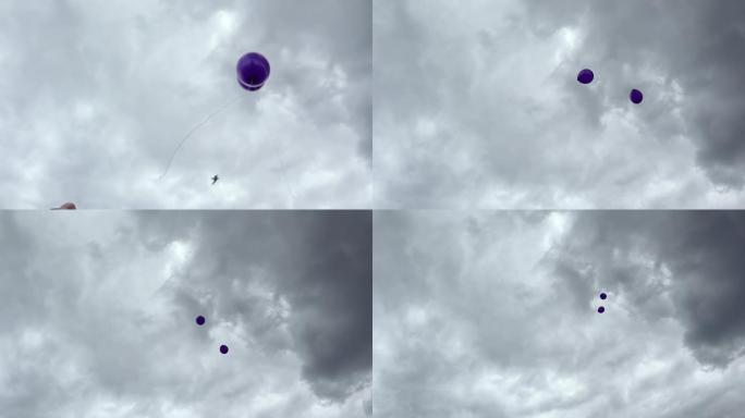 两个紫色的氦气球飞向天空。