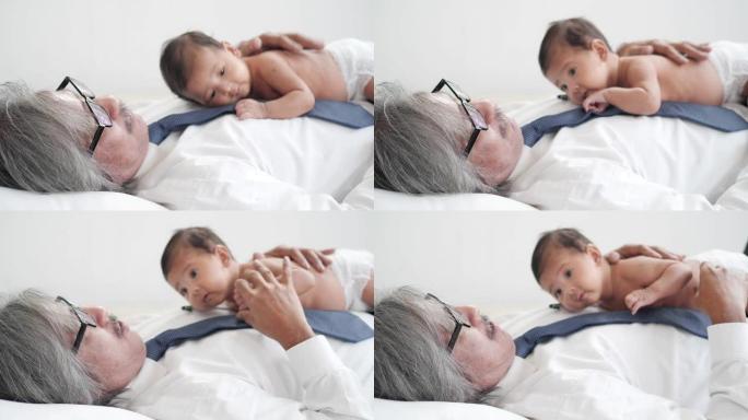祖父照顾亚洲孙子，在客厅亲吻。