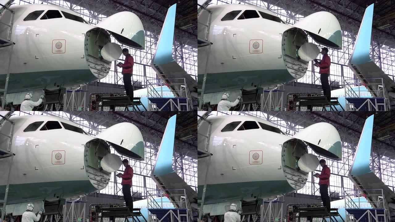 工程师修理定位客机。天线维修中的飞机。4K