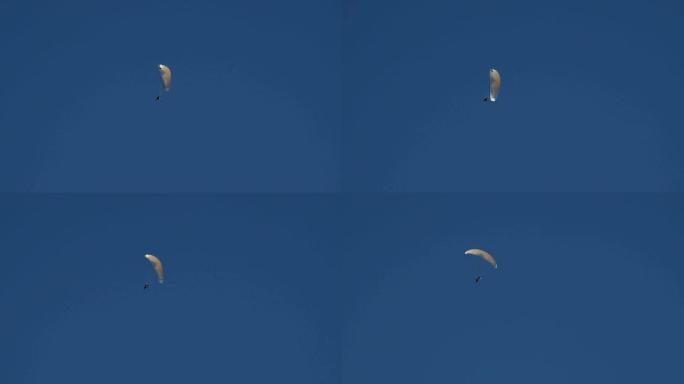在西班牙布拉瓦海岸的蓝天上，用马达滑翔伞