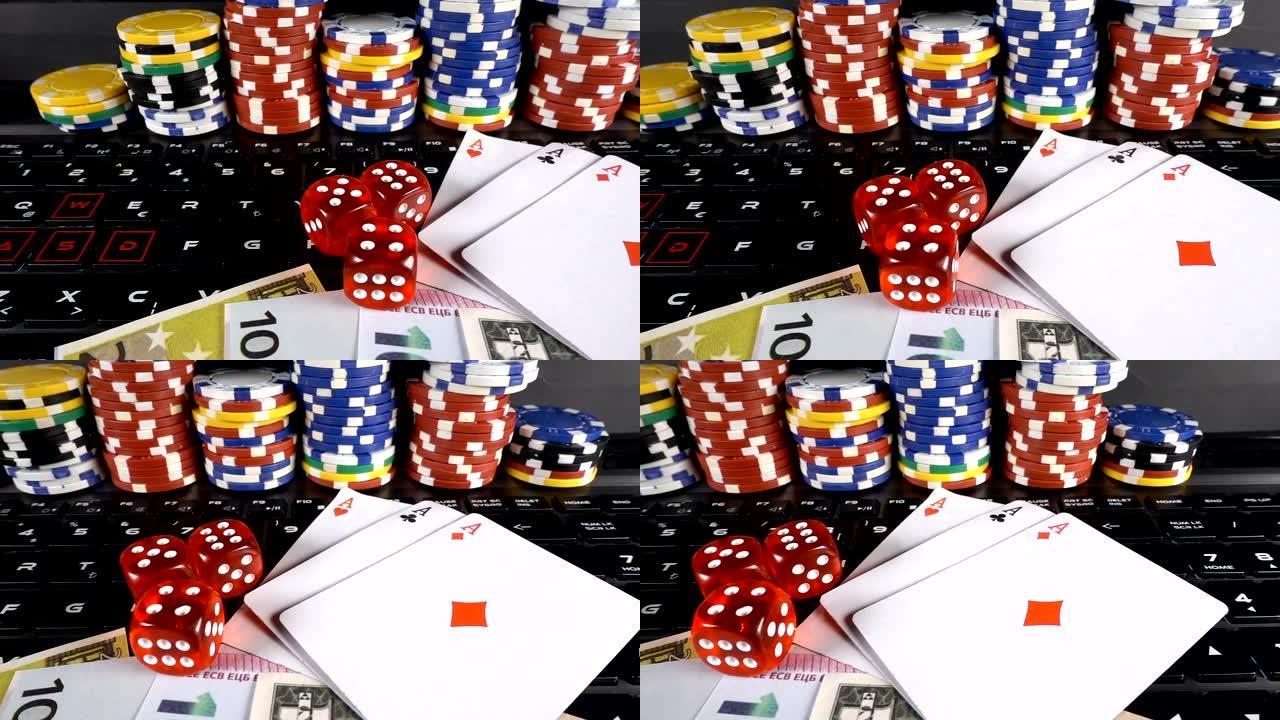 赌博钱筹码扑克牌和笔记本电脑上的骰子