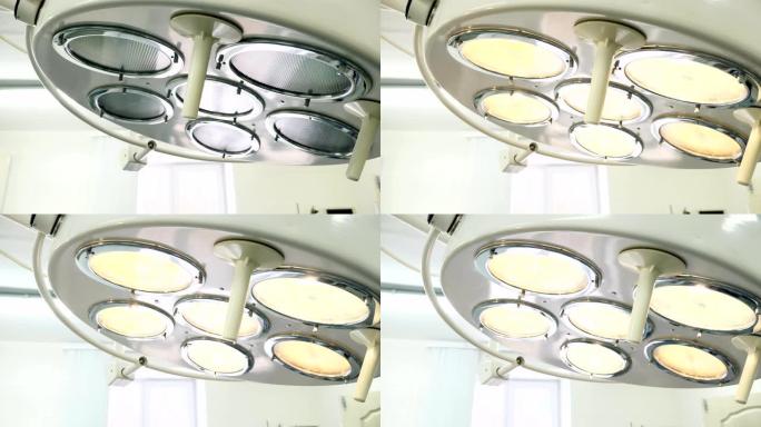手术灯亮了。手术室灯的低角度拍摄正在进行中。医疗设备概念。4k
