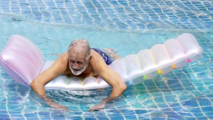 资深老人站在游泳池里。水上运动。高级活动