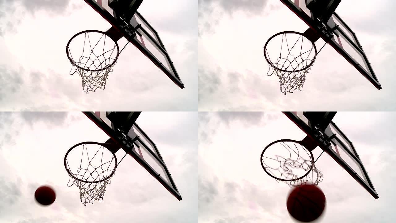 球飞过灰色天空背景下的篮球架