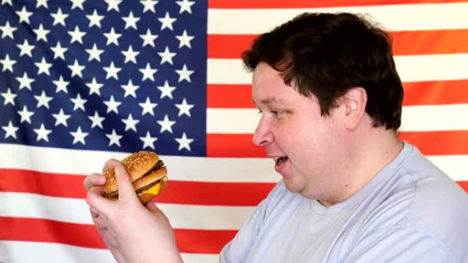 胖子拿着一块有美国国旗背景的汉堡。大家伙想要快餐。