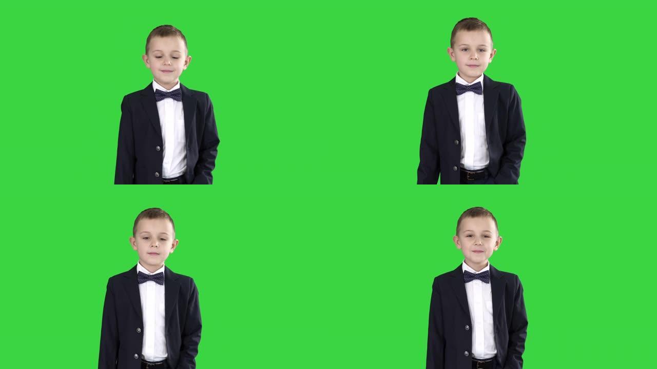 穿着正式服装的男孩在绿色屏幕上的口袋里走路，色键