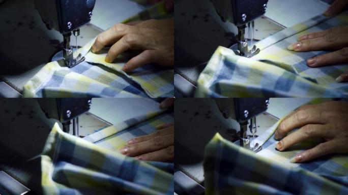特写裁缝在包缝机上包边做衣服。