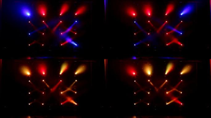 在一场有雾的音乐会上，许多聚光灯照亮了舞台。舞台灯。