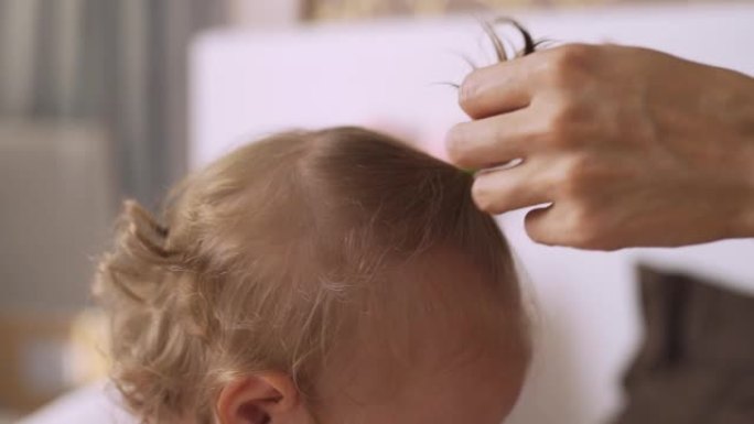 妈妈给小女儿做头发，把头发扎成马尾辫