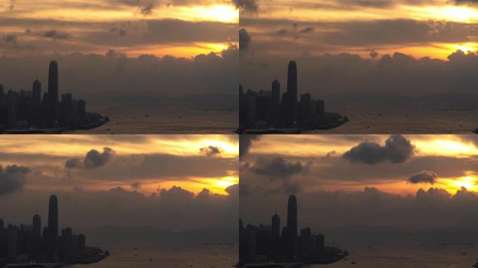 中国香港宝马山日落时，摩天大楼城市景观商业金融大厦塔楼和水上运输物流上移动云的4k延时宽镜头高角度鸟