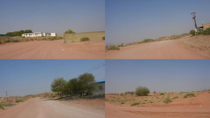 在中东阿拉伯联合酋长国靠近骆驼农场的沙质沙漠公路上驾驶汽车。快速镜头剪辑，快进。