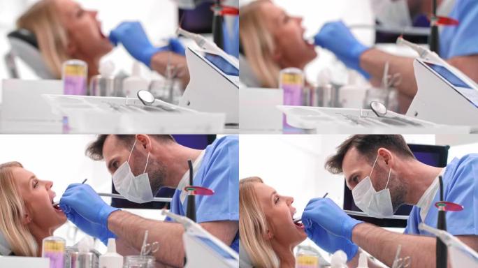 专注的牙医用牙钻清洁坏病人的牙齿