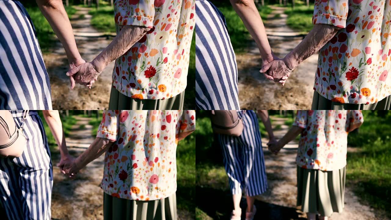 祖母和孙女牵着手在公园散步