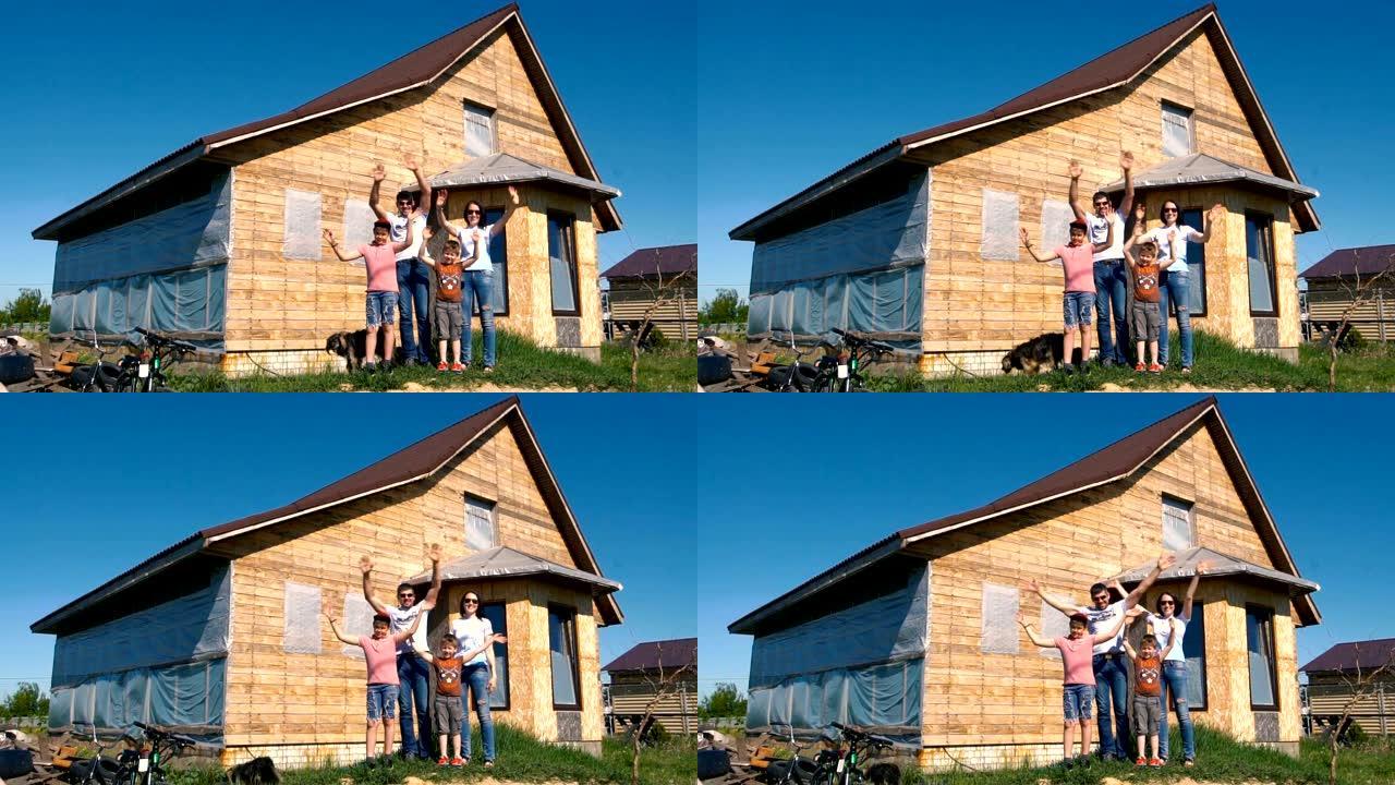 一个年轻的家庭站在木屋的背景上