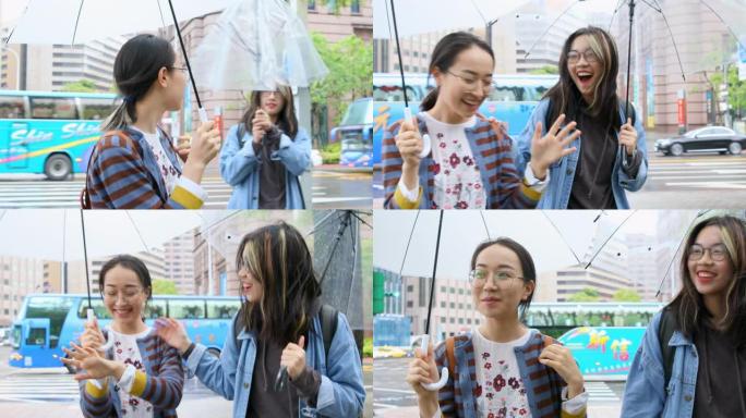 少年亚洲朋友在雨中撑伞散步