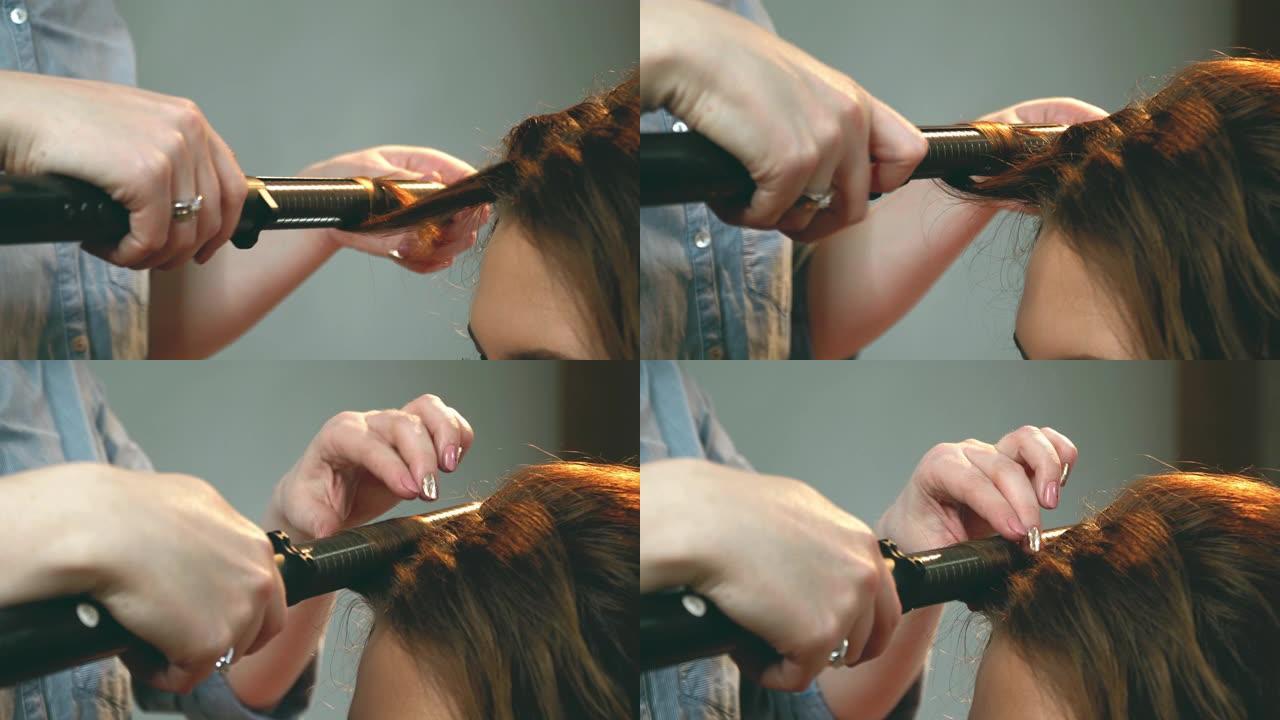 女人在发铁上做漂亮的发型。卷发会很漂亮。