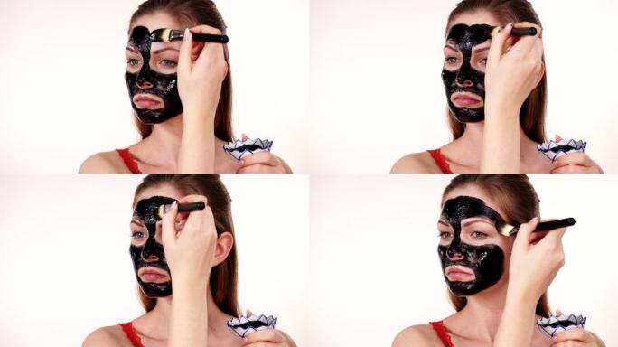 女孩在脸上涂黑色碳面膜