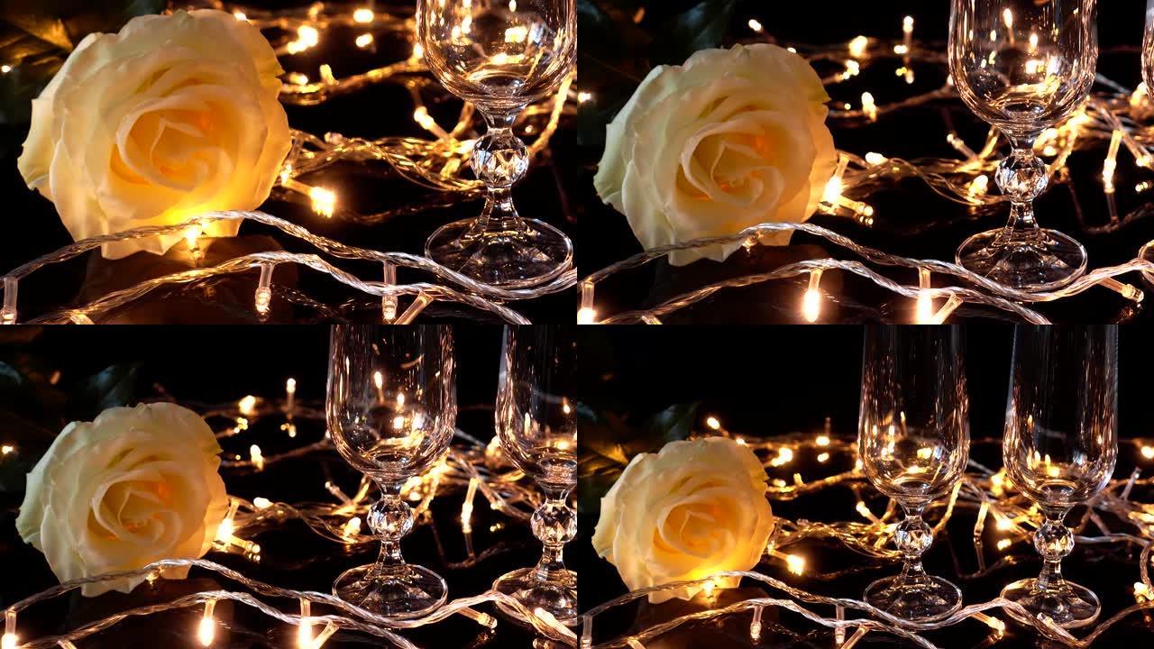 明亮的花环背景下的香槟和玫瑰眼镜。