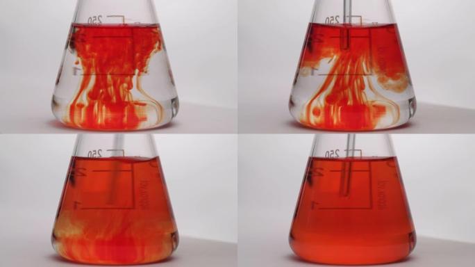 化学试剂的混合。液体在烧瓶中变色。烧瓶中化学反应的特写。孤立，在白色背景上