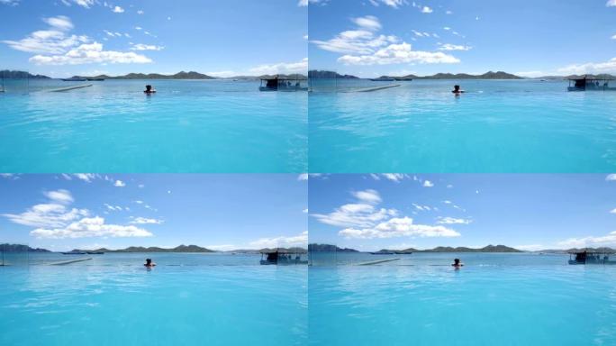 女人在无边泳池享受暑假