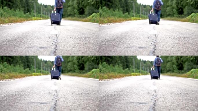 女人带着轮子包和背包沿着乡村道路走开