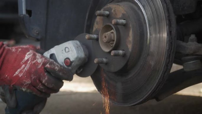 机械师用研磨机切割汽车的车轮