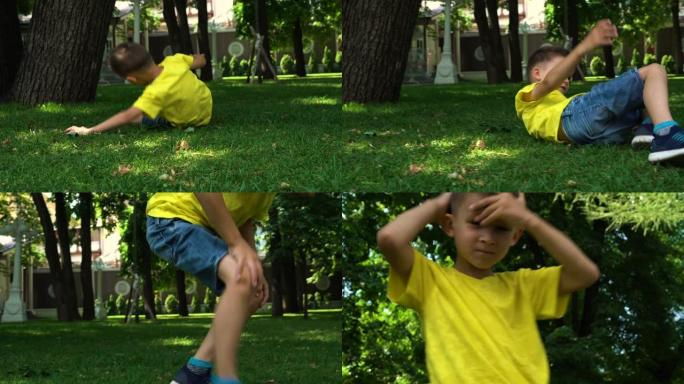 一个六岁的孩子在公园的草坪上摔倒。