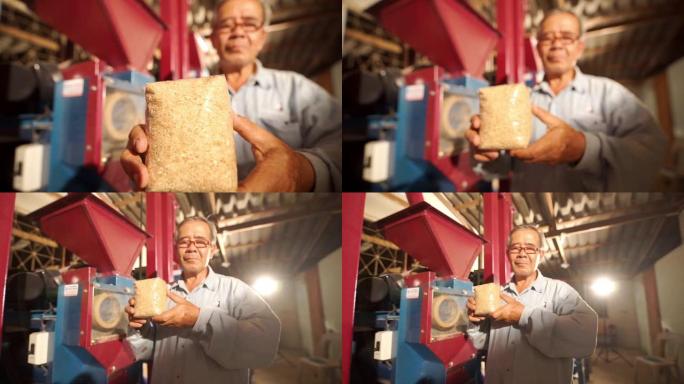 多莉女士推出了高级农民的相机，自豪地展示了背景模糊的新鲜碾碎的糙米。