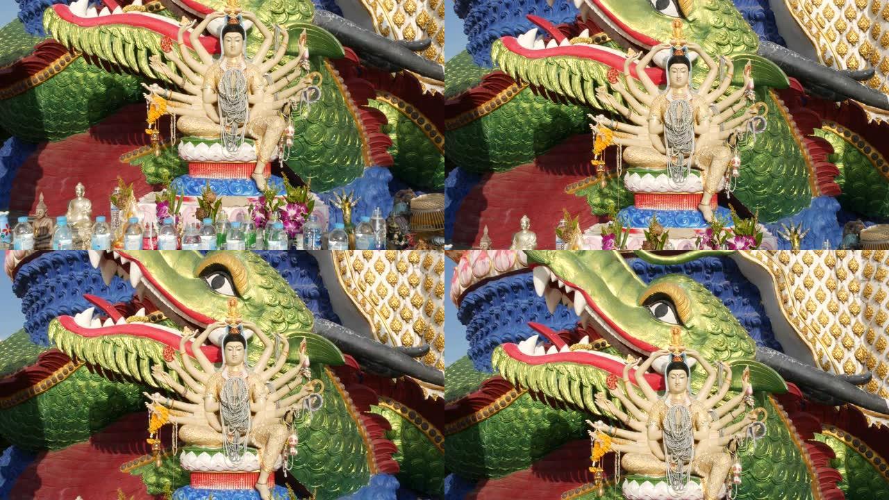 佛寺院子里的观音像。关阴雕像，多臂，位于东方国家传统佛教寺庙院子里，面对万里无云的蓝天。Wat Pl