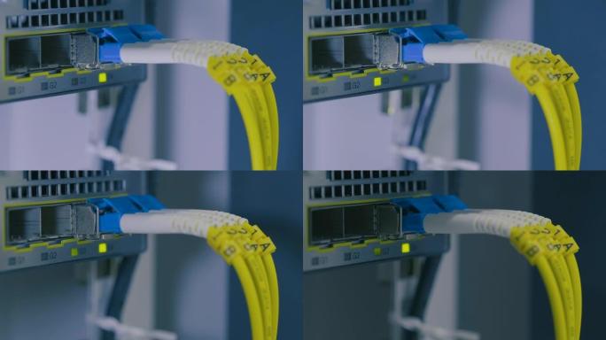 光影移动。模块端口上的光缆。用于数据中心机房高速网络的网络千兆交换机。