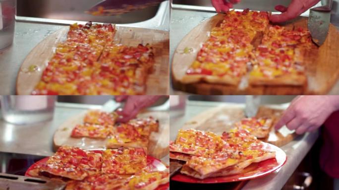 一个女人在厨房用大厨刀将新鲜出炉的热气腾腾的比萨饼切成薄片。
