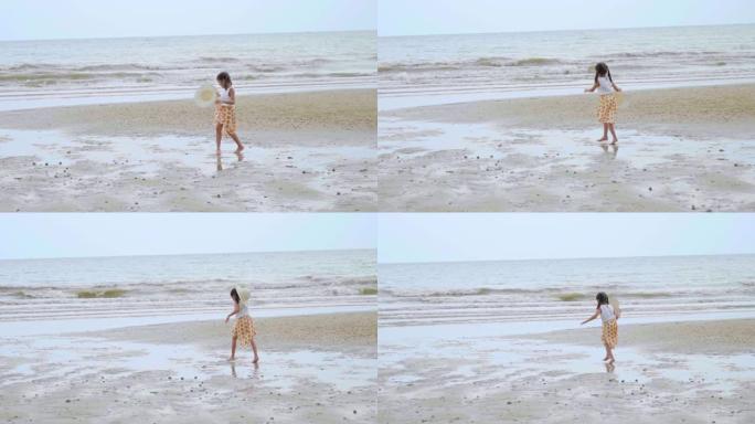 亚洲小女孩在沙滩上散步