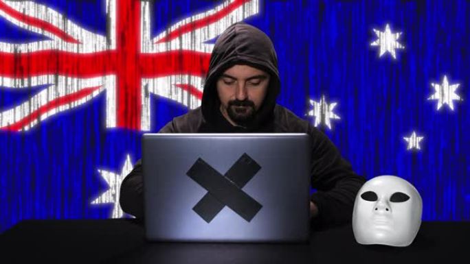 黑客黑客在他的笔记本电脑上键入代码，背景中有澳大利亚国旗和二进制代码动画覆盖