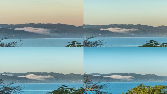 当雾从大西洋的蒙特哥湾牙买加的臀部地带滚下并越过海湾的山丘时，将雾的时光倒流缩小，当鸟和船飞过时，它