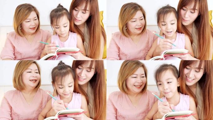 亚洲的母亲和母亲在卧室教女儿写作。