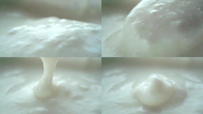 微距视频拍摄，杯子里用勺子混合酸奶的慢动作